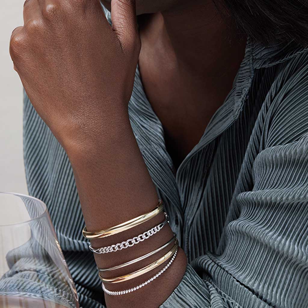 Gold hinged cuff bracelet on model wrist showing fit