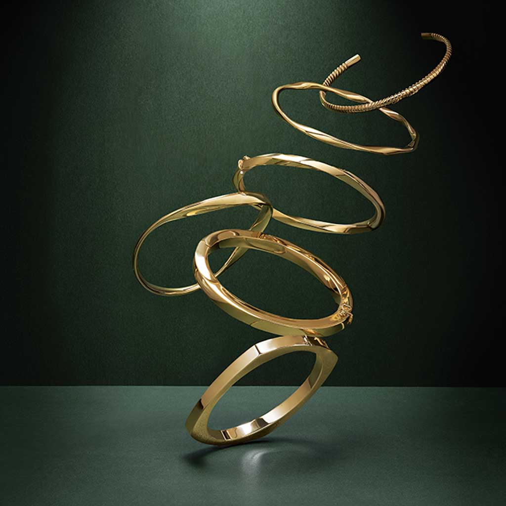 Wide hinged gold bangle stacked and styled