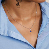 minimalist silver rolo chain necklace close up shown on model with a charm