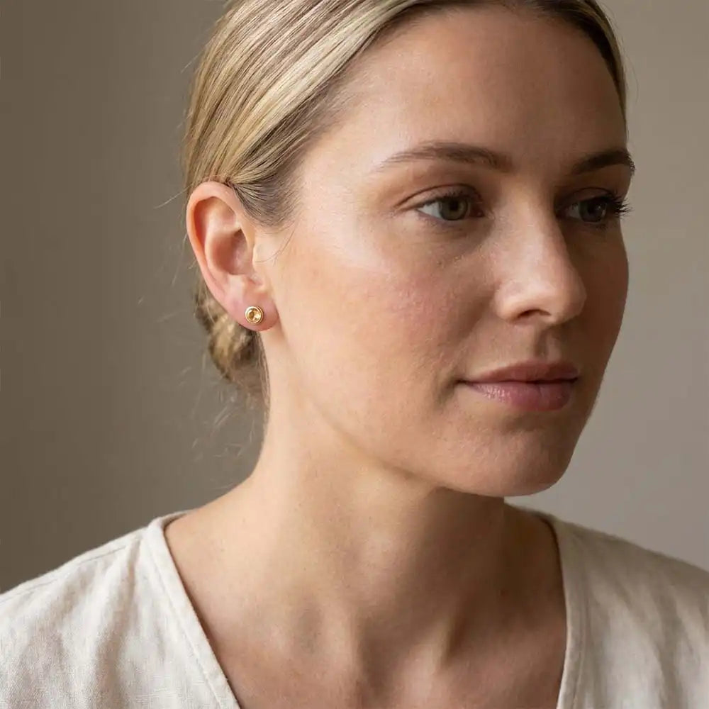 Citrine birthstone stud earrings on model, golden yellow studs at ear