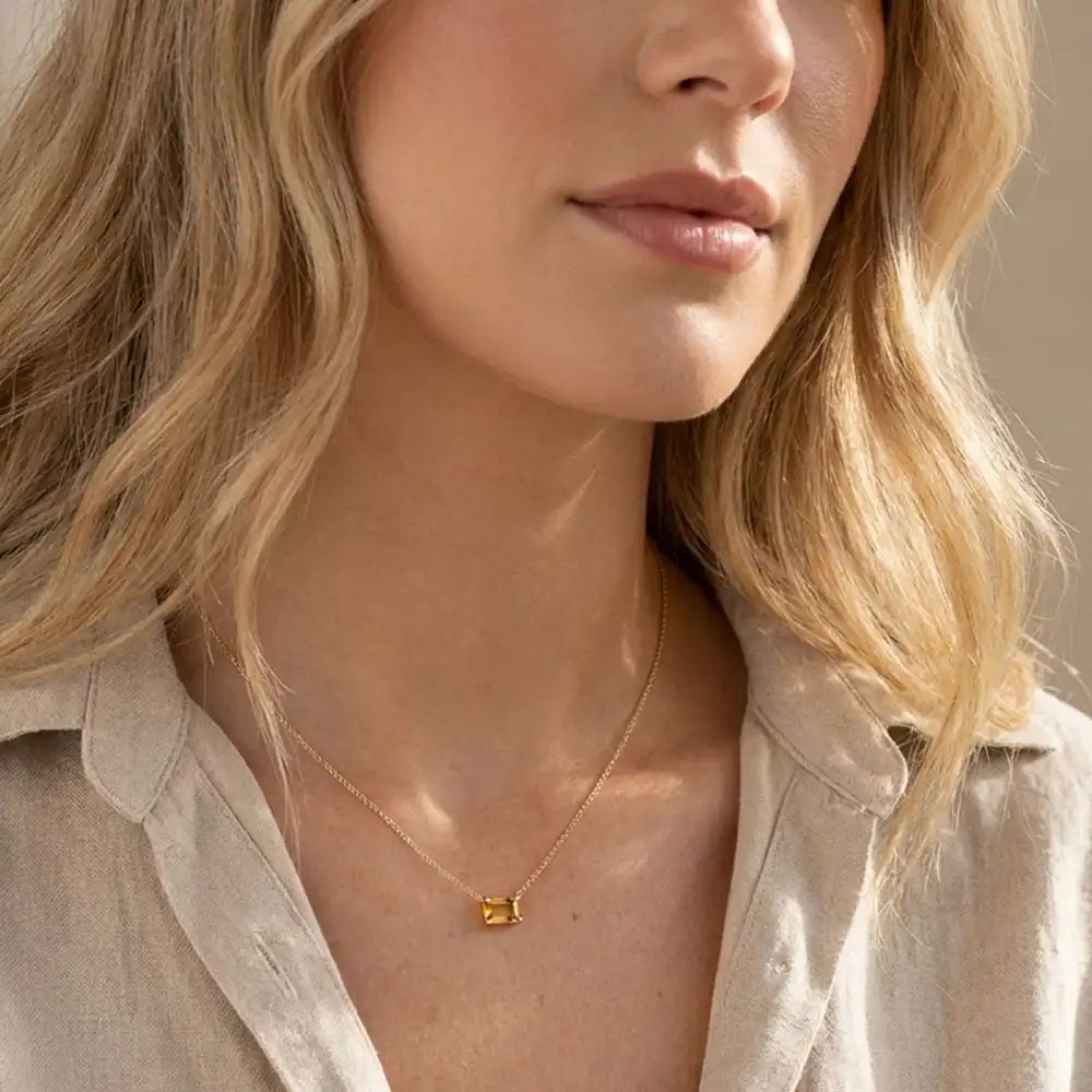Minimalist birthstone necklace featuring a 5x3mm emerald shown on model variant-14K-yellow-gold variant-14K-white-gold variant-14K-rose-gold variant-Sterling-silver