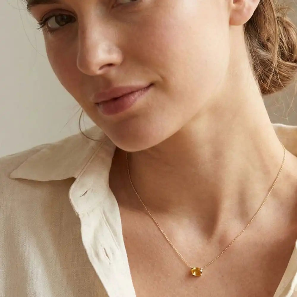 Oval citrine prong-set necklace on fine gold chain on model variant--14K-rose-gold variant--14K-white-gold variant--14K-yellow-gold variant--Sterling-silver variant--Citrine