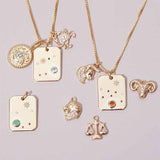 Constellation charm necklace styled with other gold zodiac charms
