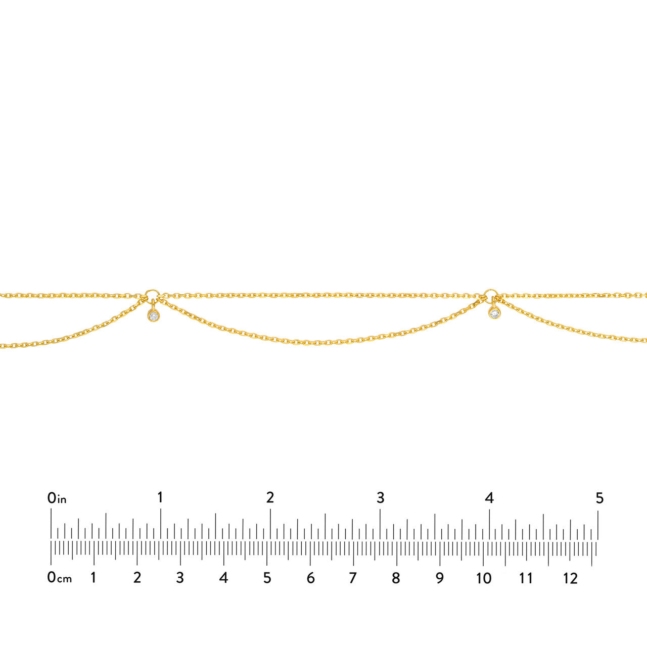 Diamond Drape necklace in 14K yellow gold with a ruler for scale.