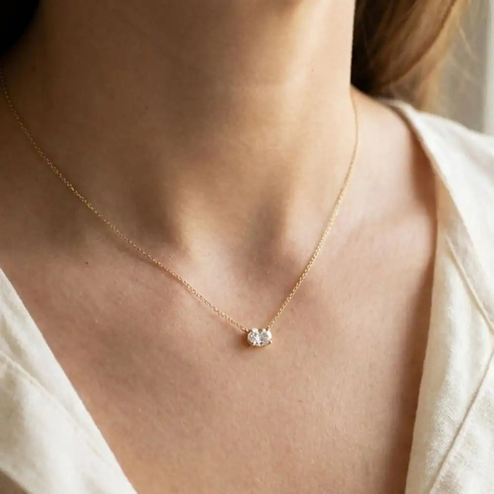 Oval prong-set necklace on fine gold chain on model variant--14K-rose-gold variant--14K-white-gold variant--14K-yellow-gold variant--Sterling-silver variant--White-sapphire