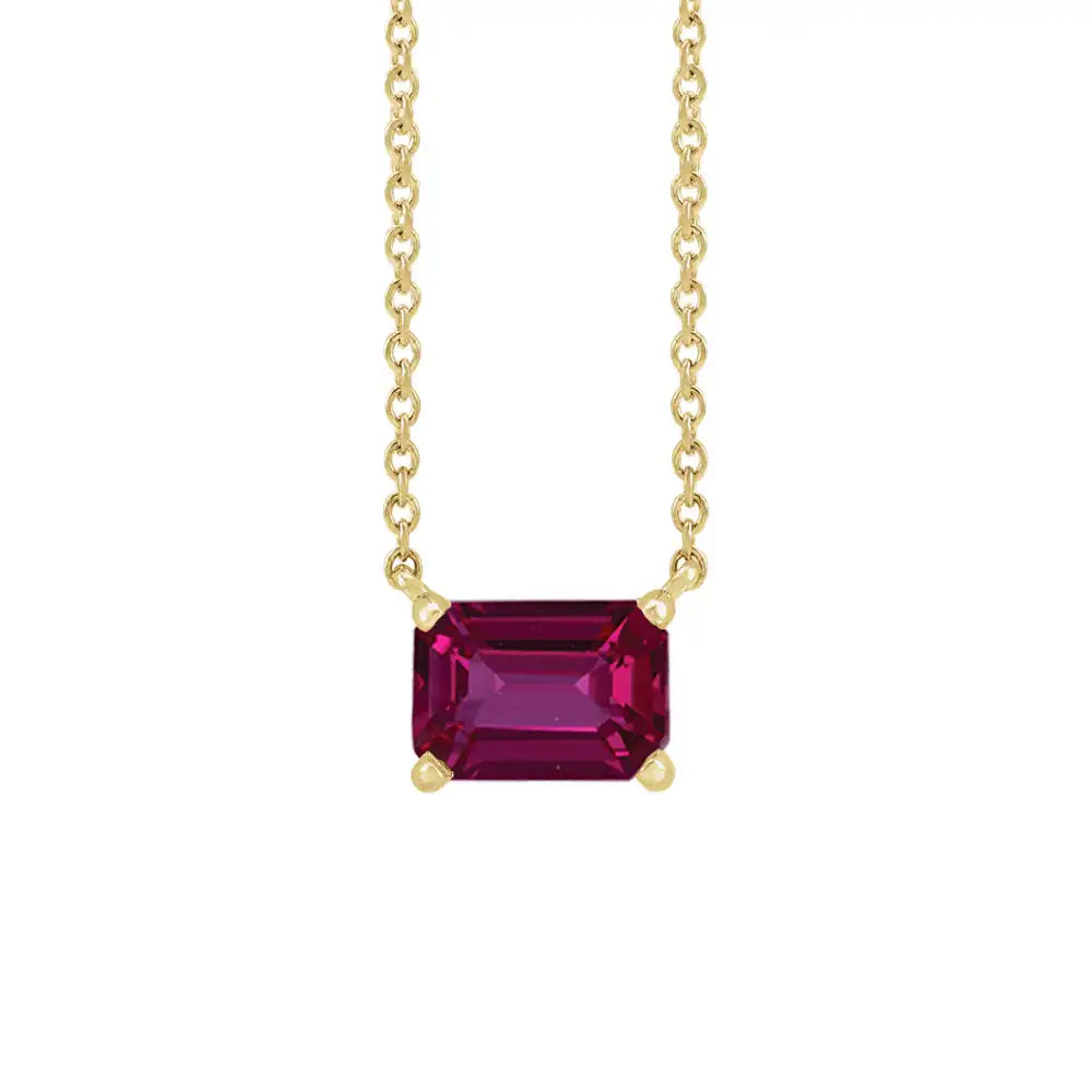 Minimalist 14K yellow gold Ruby birthstone necklace featuring a 5x3mm emerald-cut pendant. variant--Ruby variant--14K-yellow-gold