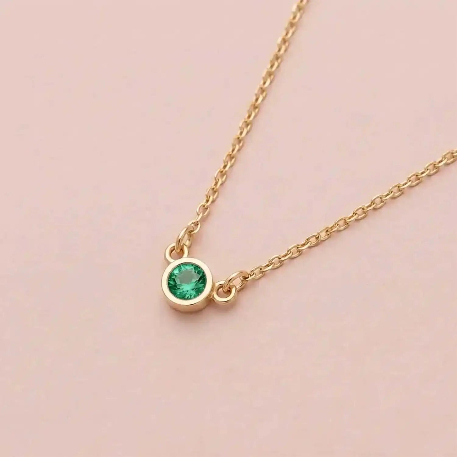 Bezel-set emerald birthstone necklace in 14K yellow gold on cable chain variant--Sterling silver