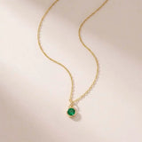 Natural emerald birthstone charm necklace in 14K yellow gold, bezel-set pendant on cable chain