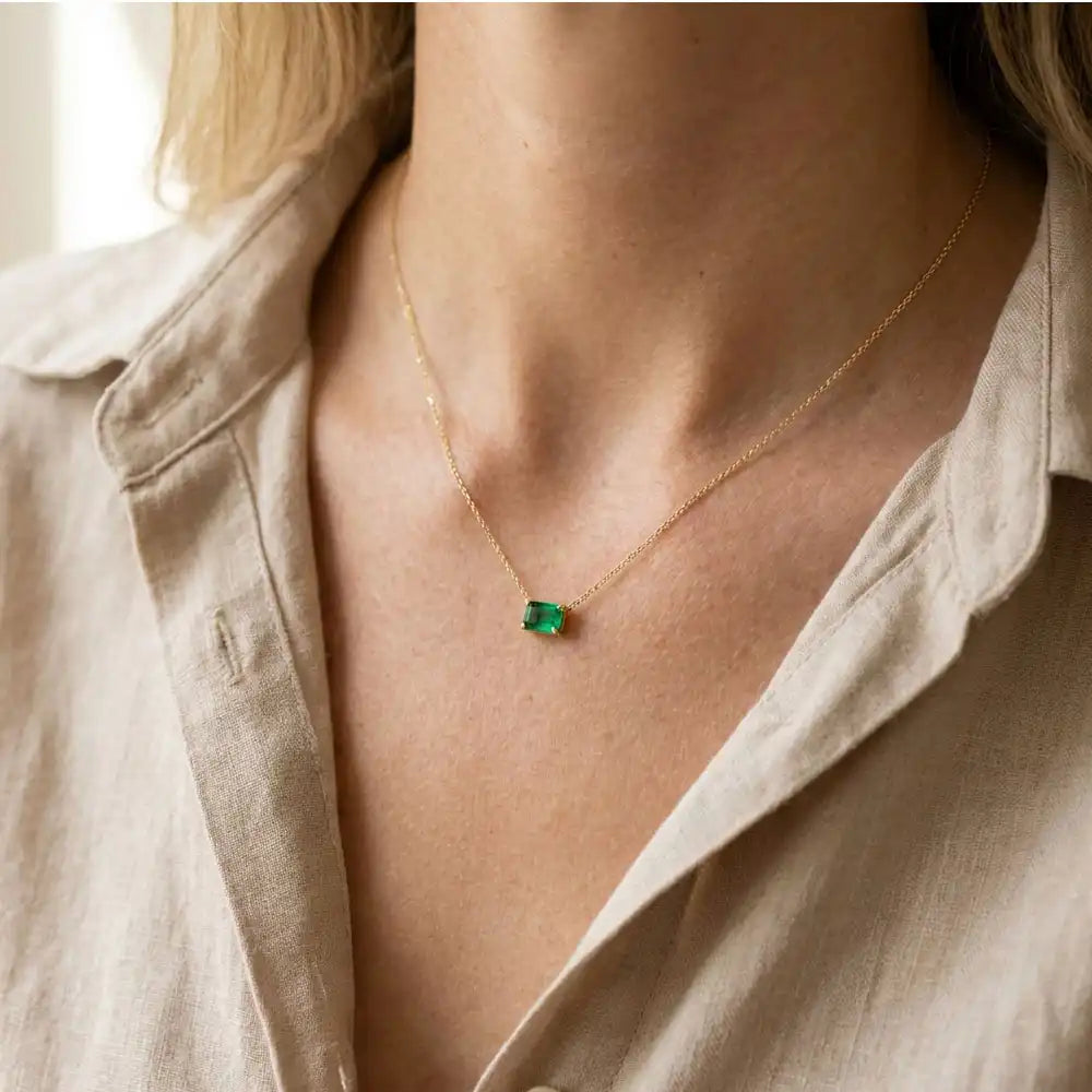 Minimalist birthstone necklace featuring a 5x3mm emerald shown on model variant-14K-yellow-gold variant-14K-white-gold variant-14K-rose-gold variant-Sterling-silver

