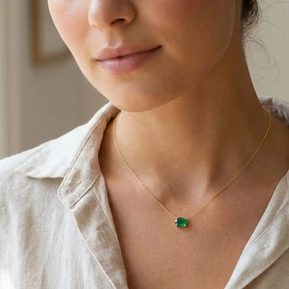 Oval emerald prong-set necklace on fine gold chain on model variant--14K-rose-gold variant--14K-white-gold variant--14K-yellow-gold variant--Sterling-silver variant--Emerald