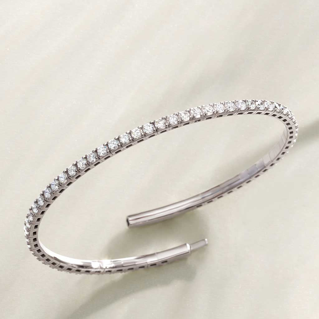 Flexible diamond bangle bracelet in 14K white gold with round hand-set diamonds