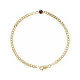 Minimalist bracelet in 14K gold with bezel-set garnet gemstone at the center.