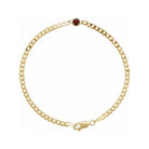 Minimalist bracelet in 14K gold with bezel-set garnet gemstone at the center.