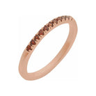 14K rose gold stacking band featuring a petite garnet gemstone for daily elegance.