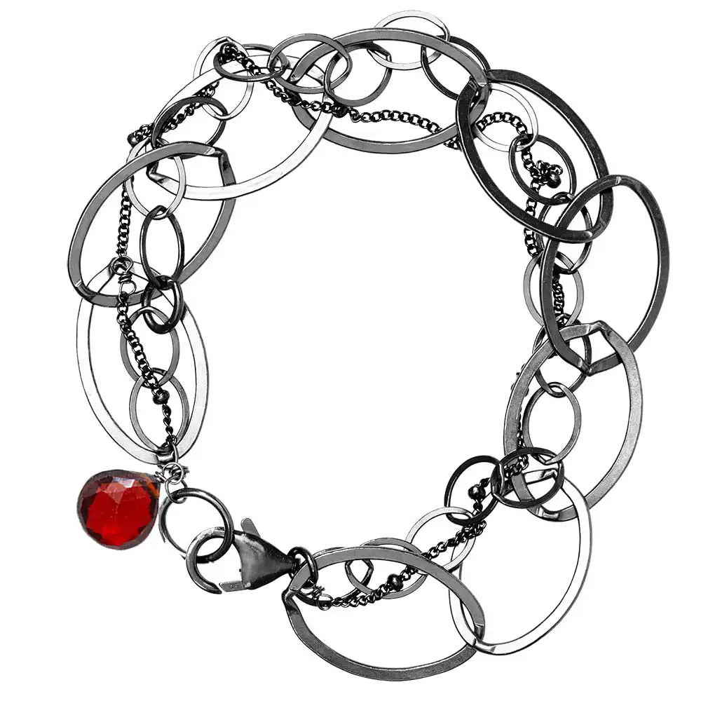 Natural garnet woven chain bracelet in sterling silver, flat lay on neutral background sterling silver variant--Oxidized-sterling-silver