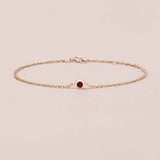 Bezel-set garnet bracelet in 14K yellow gold on adjustable curb chain