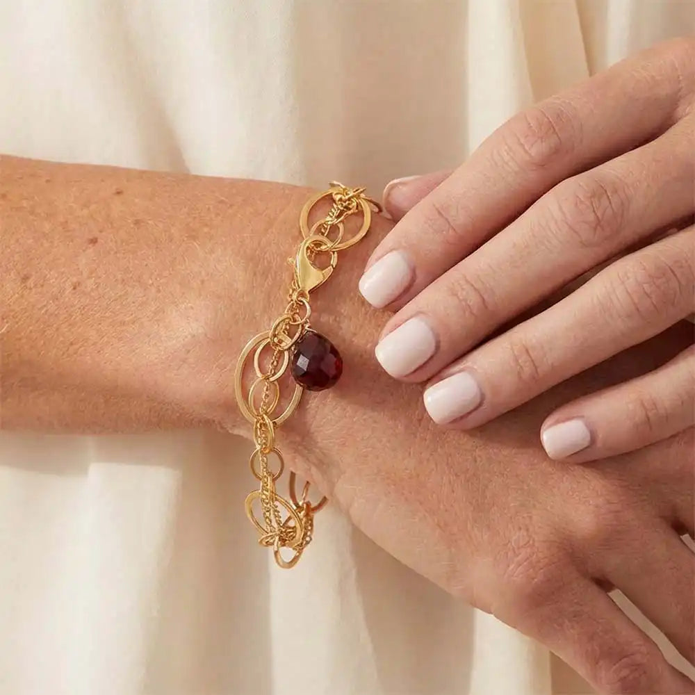Natural garnet woven chain bracelet in sterling silver, close-up of setting in gold-fill variant--Gold-fill variant--Sterling-silver variant--Oxidized-sterling-silver variant--Garnet