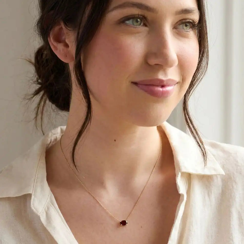 Oval garnet prong-set necklace on fine gold chain on model variant--14K-rose-gold variant--Garnet variant--14K-white-gold variant--14K-yellow-gold variant--Sterling-silver