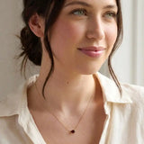 Oval garnet prong-set necklace on fine gold chain on model variant--14K-rose-gold variant--Garnet variant--14K-white-gold variant--14K-yellow-gold variant--Sterling-silver