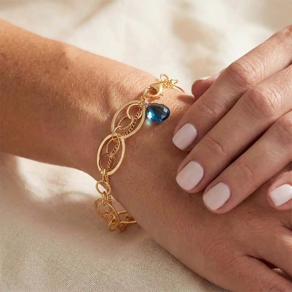 Natural london blue topaz woven chain bracelet in sterling silver, close-up of setting in gold-fill variant--Gold-fill variant--Sterling-silver variant--Oxidized-sterling-silver variant--London-Topaz
