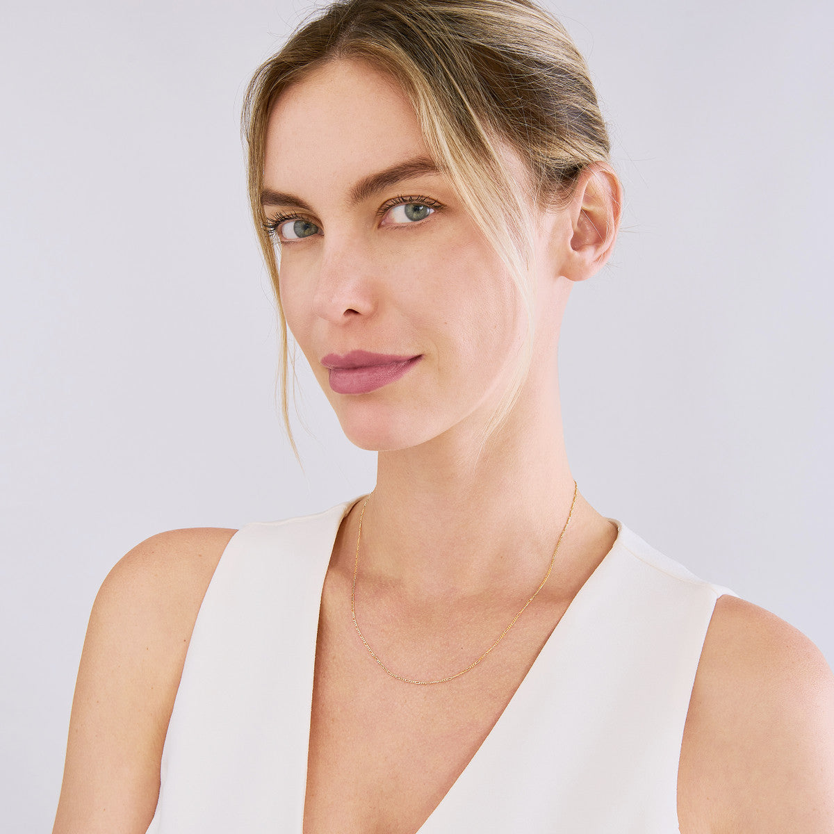 fine solid gold figaro chain necklace for everyday wear shown on model