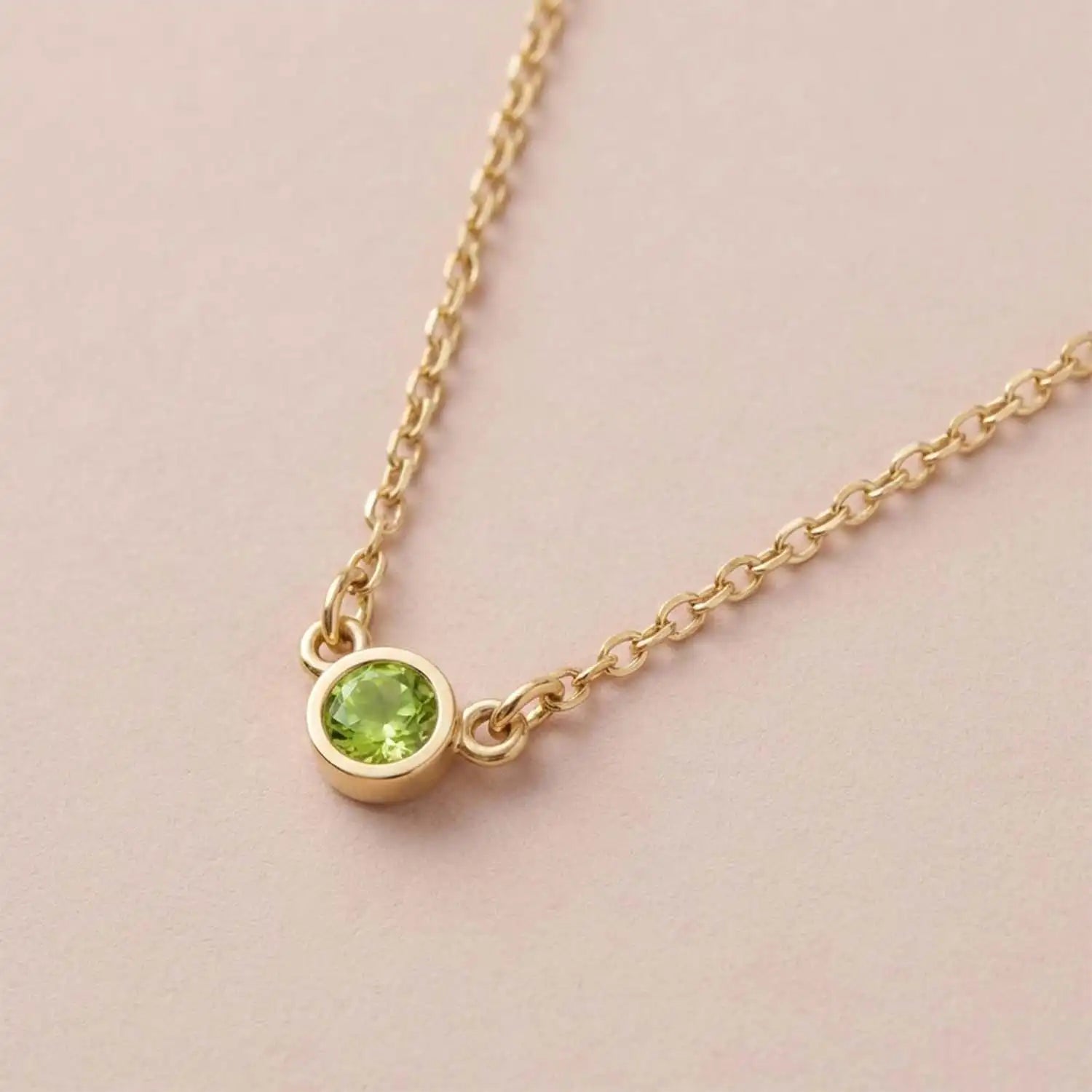 Bezel-set peridot birthstone necklace in 14K yellow gold, product view