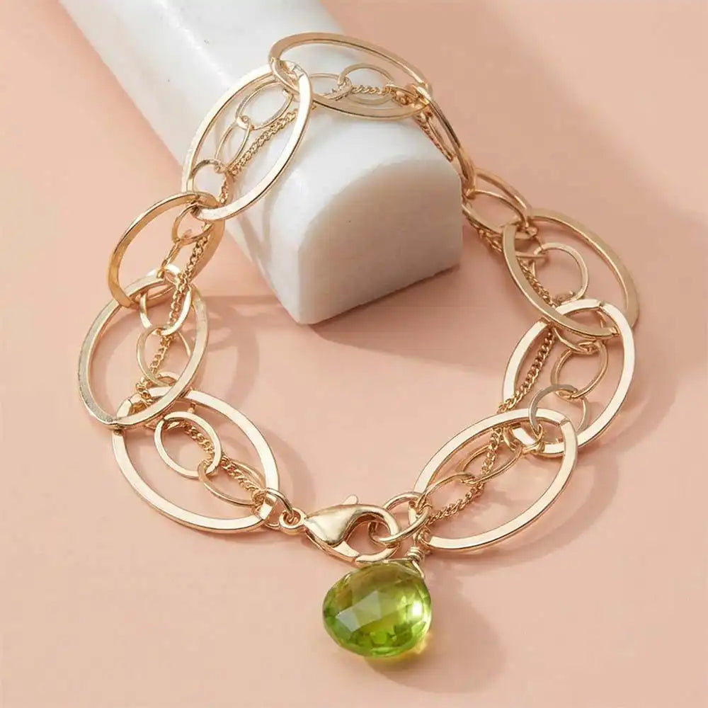 Natural peridot woven chain bracelet in sterling silver, styled on chain bracelet variant--Gold-fill variant--Sterling-silver variant--Oxidized-sterling-silver variant--Peridot