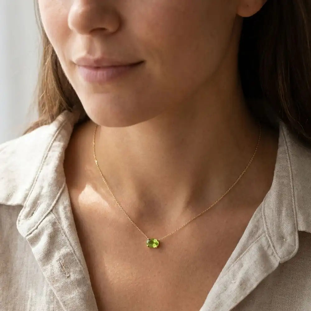 Oval peridot prong-set necklace on fine gold chain on model variant--14K-rose-gold variant--14K-white-gold variant--14K-yellow-gold variant--Sterling-silver variant--Peridot