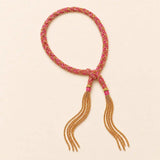 Pink braided chain and silk tassel bracelet in 14K gold-fill, flat lay