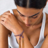 Purple braided chain and silk tassel bracelet in 14K gold-fill worn on model