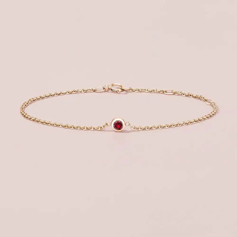 bezel set ruby bracelet in 14k gold