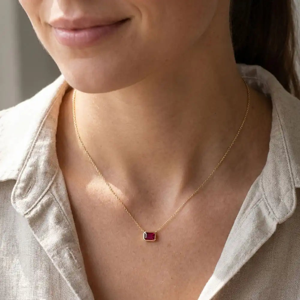 Minimalist birthstone necklace featuring Ruby shown on model variant--14K-yellow-gold variant--14K-white-gold variant--14K-rose-gold variant--Sterling-silver variant--Ruby