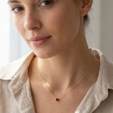 Minimalist oval ruby necklace in yellow gold on a model variant--Sterling-silver variant--14K-white-gold variant--Ruby variant--14K-yellow-gold variant--14K-rose-gold