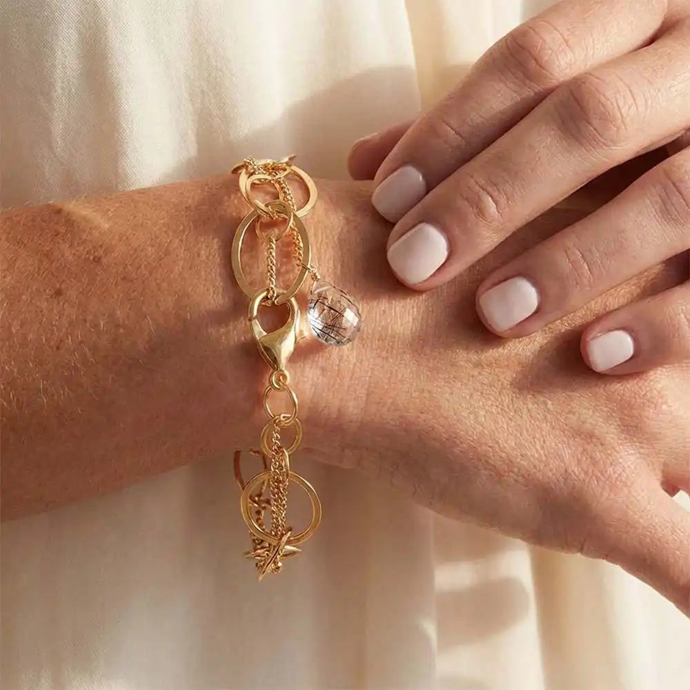 Natural rutilated quartz woven chain bracelet in sterling silver, close-up of setting in gold-fill
