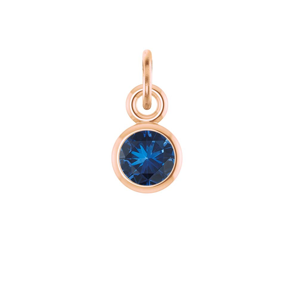 Sapphire birthstone charm bezel-set in 14k rose gold — timeless blue gemstone jewelry.