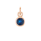 Sapphire birthstone charm bezel-set in 14k rose gold — timeless blue gemstone jewelry.