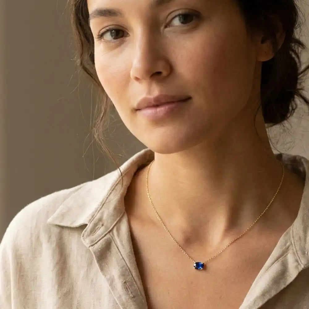 Oval sapphire prong-set necklace on fine gold chain on model variant--14K-rose-gold variant--14K-white-gold variant--14K-yellow-gold variant--Sterling-silver variant--Sapphire