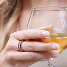 Stackable birthstone rings shown on a model