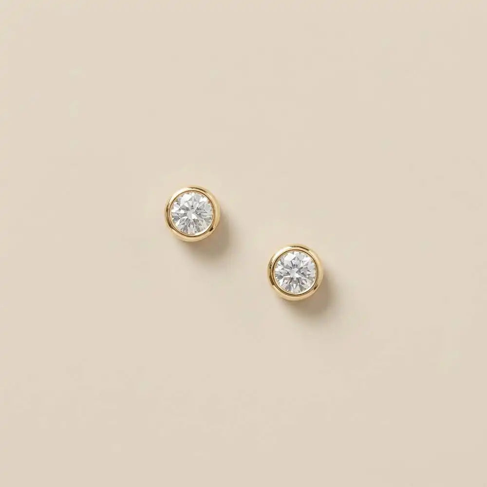 White sapphire stud earrings in 14K gold, 5mm brilliant stone, product shot