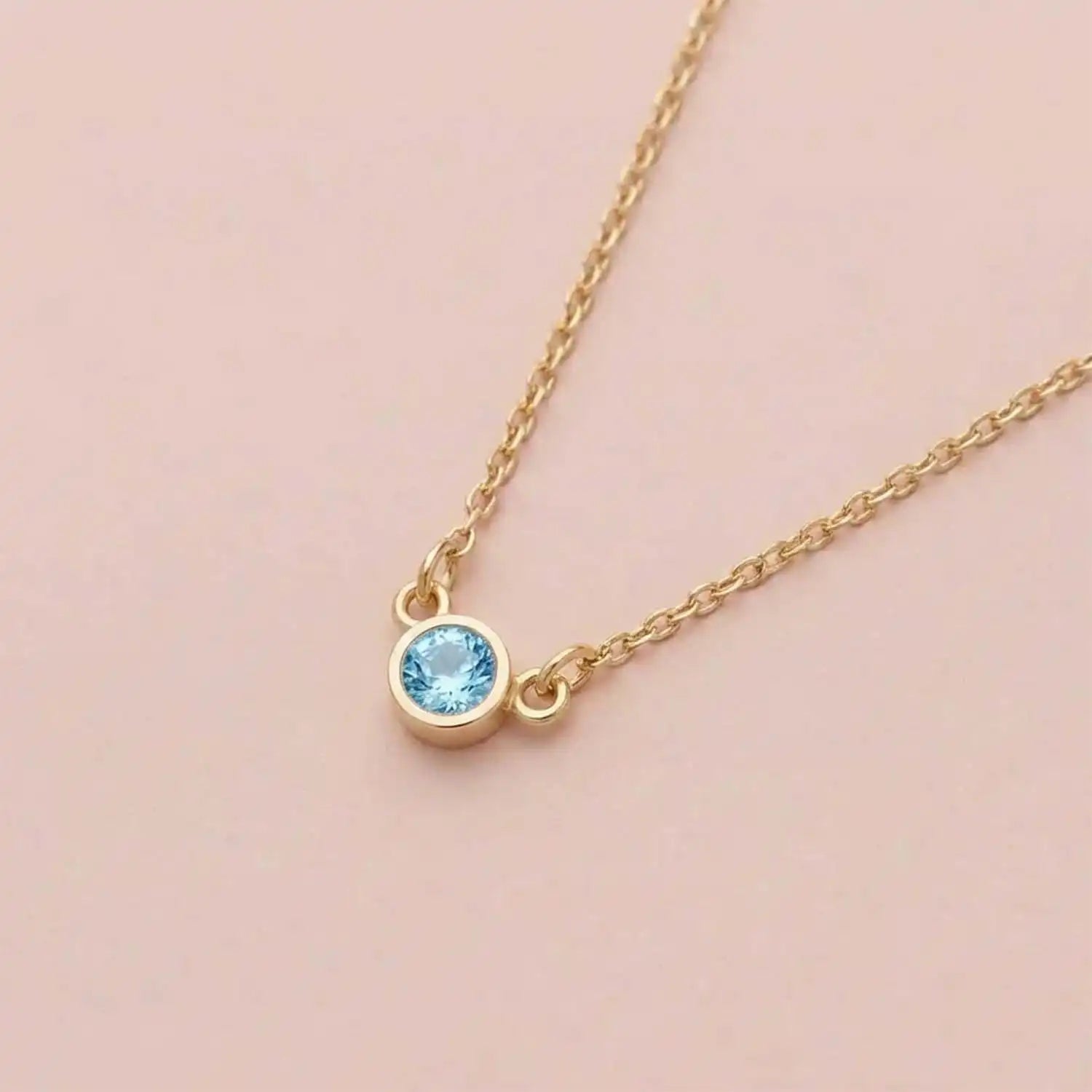 Bezel-set blue zircon birthstone necklace in 14K white gold on cable chain