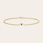 Bezel-set alexandrite bracelet flatlay showing color variation in daylight