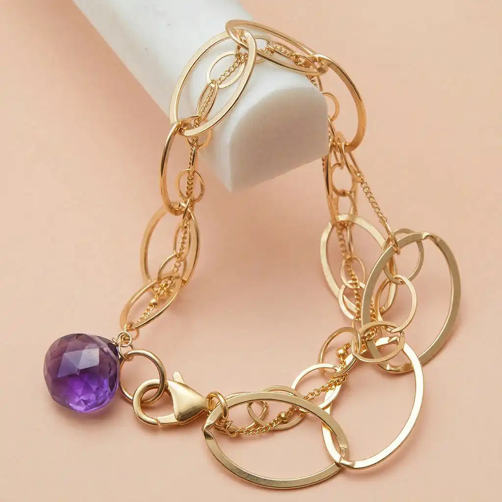 Amethyst bracelet featuring a deep purple amethyst on a gold woven chain