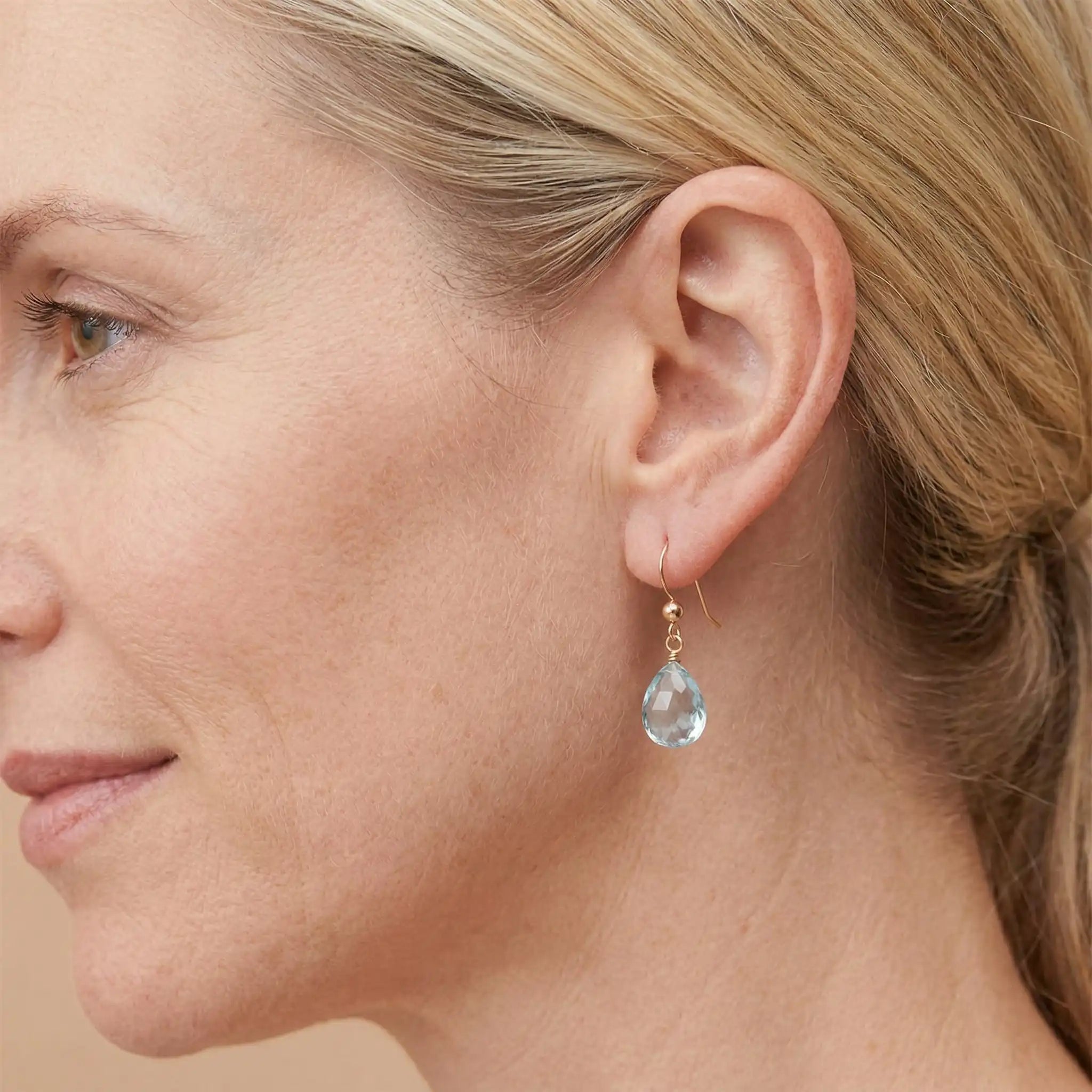 Drop earring in gold-fill shown on model