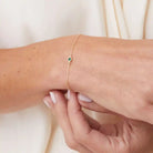 Model wearing bezel-set birthstone bracelet.