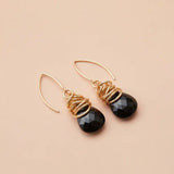 Black sapphire dangle earrings product shot, genuine deep black stone in sculptural bezel setting