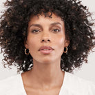 25mm 4mm wide gold hoop earrings worn on ear