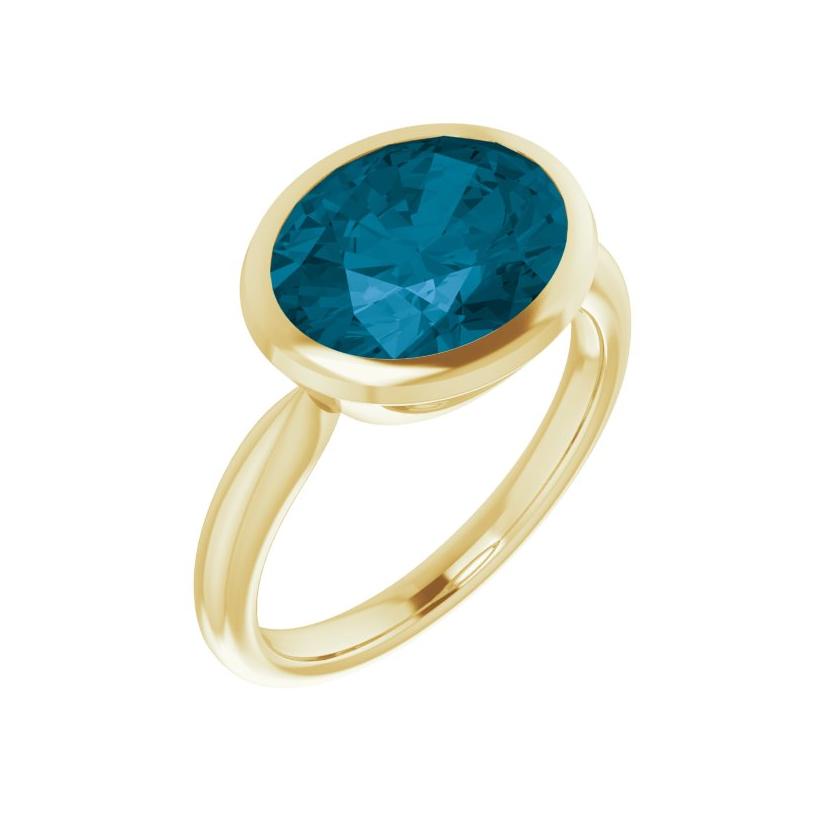 Bold blue topaz statement ring in yellow gold, wide oval stone set east-west