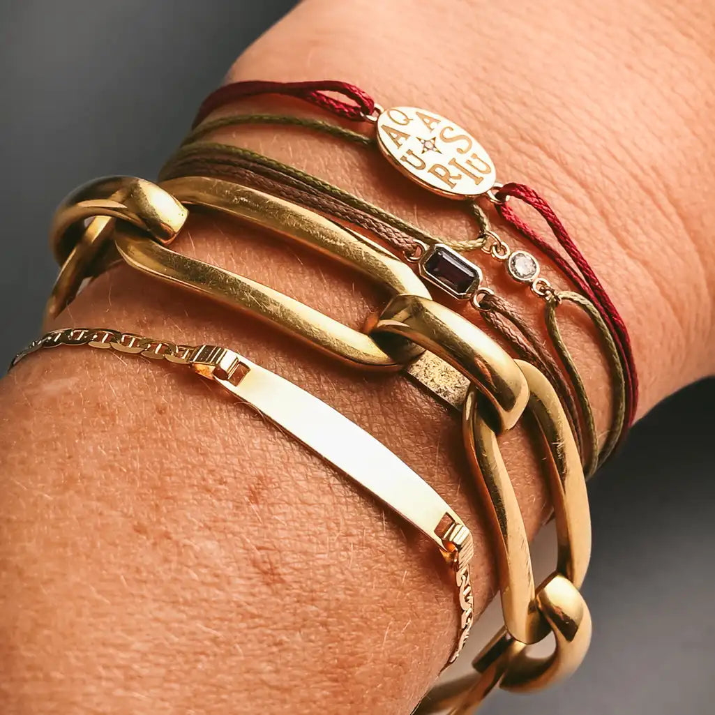Luxury 18K gold link bracelet with push clasp on model bracelt stack