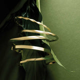 Polished 14K gold hinged bangle bracelet detail