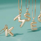 Rounded initial charm close up with high-polish finish variant--A variant--14K-yellow-gold